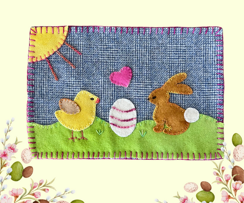 Photo of a wool appliqué mug rug with a yellow chick and a brown bunny and perle cotton embellishments.