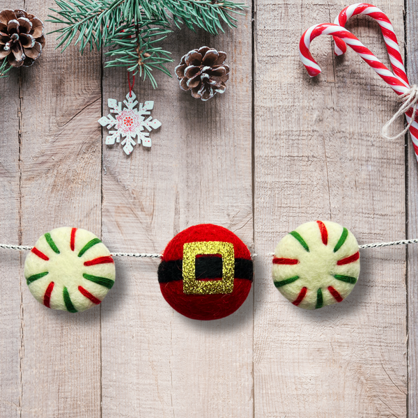 Photo of felt ball ornaments two as christmas peppermint candy and one as a santa belt.