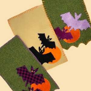 photo of three bat and moon wool applique mug rugs