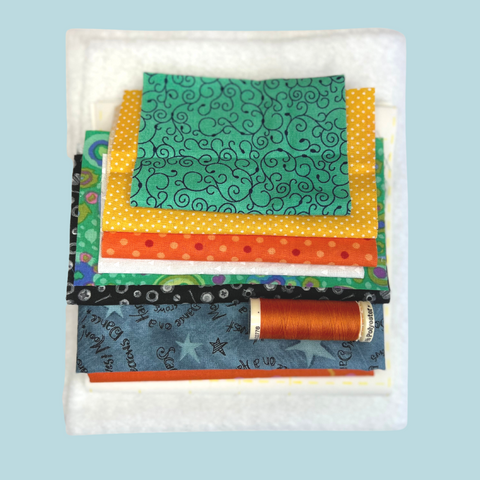 photo of fabric bundle including fusible fleece and thread for sewing the quilted Candy Cornucopia Table Mat