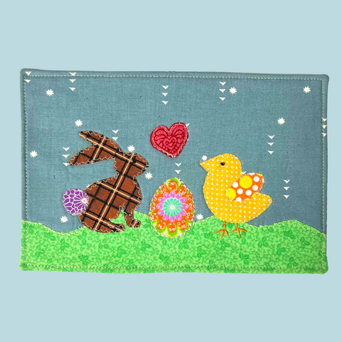 Photo of an applique bunny and chick with an Easter Egg between them.