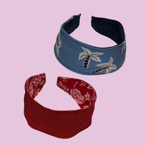photo of a two headbands one red and one blue each with a pattern on the reversible side