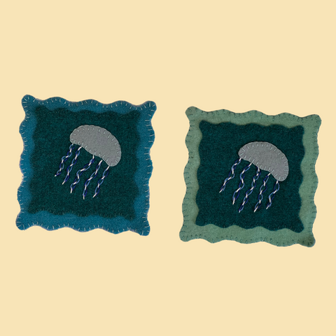 photo of 2 wool applique jellyfish coasters with hand embroidery stitching