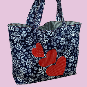 Photo of a reversible tote bag sewing kit with three applique hearts