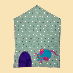 Photo of a mouse pad in the shape of a house with a mouse hole door and an applique mouse