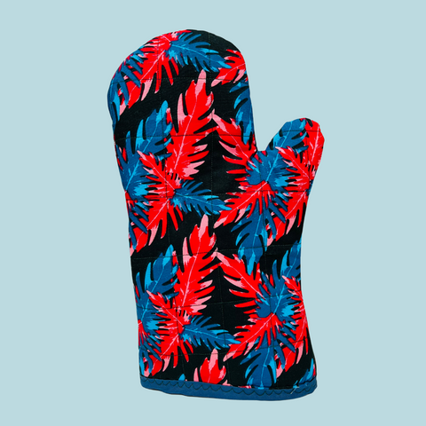 photo of an oven mitt with blue and red floral fabric on a light blue background