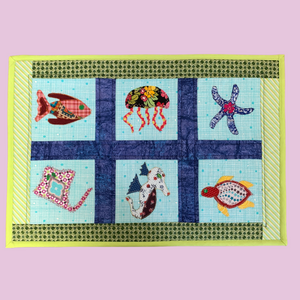 Photo of a quilted and appliqued under the sea table mat sewing kit