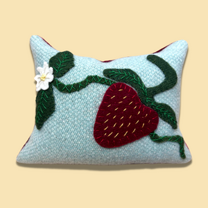photo of a wool pincushion with strawberry, flower, and leaves applique plus embroidery