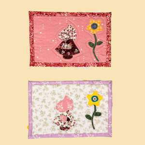 Photo of 2 cotton mug rugs with SunBonnet Sue looking at a sunflower